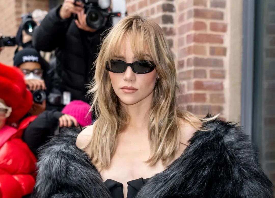 Suki's soft wolf cut with curtain bangs and airy layers. The 2026 direction is less rebellious, more wearable